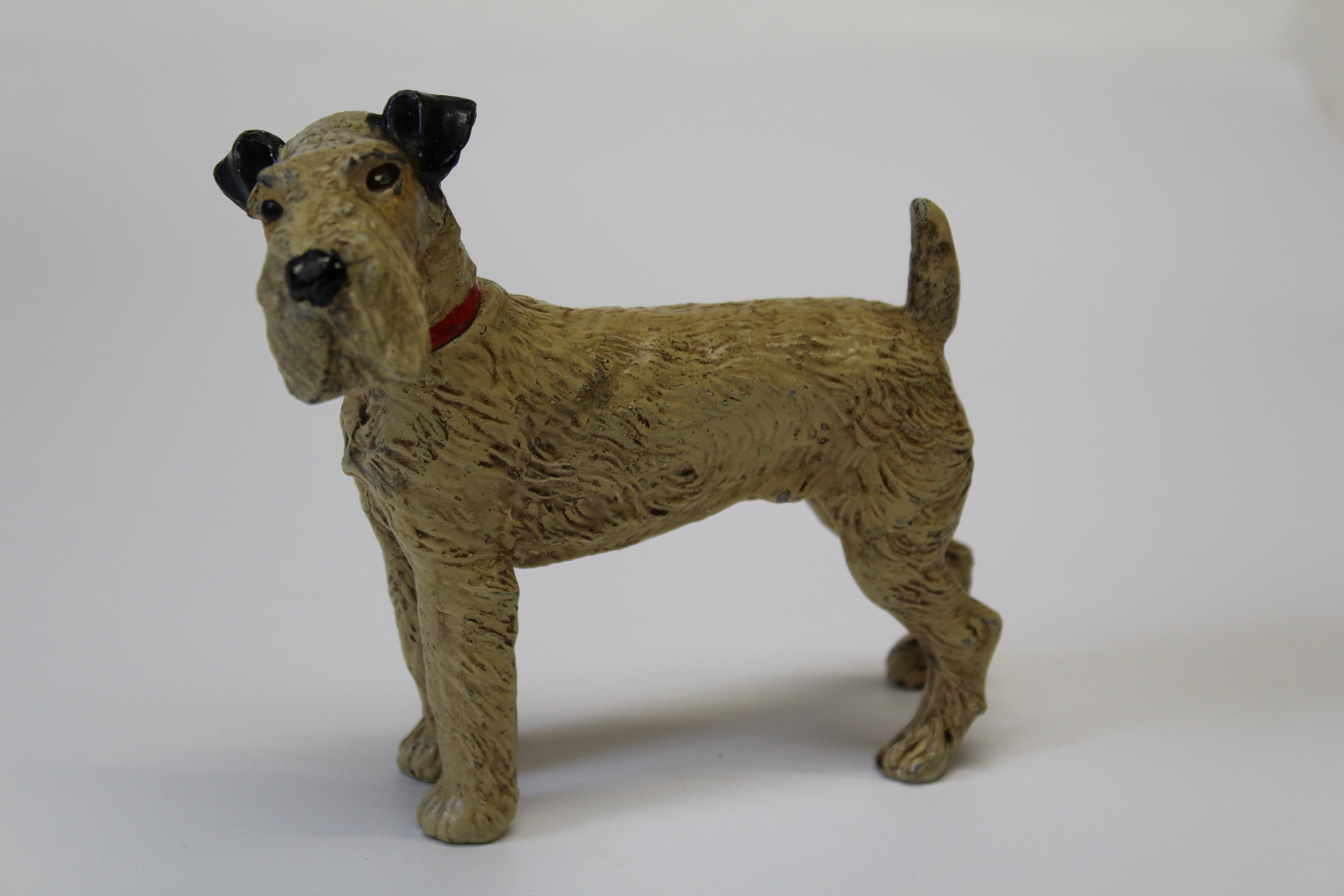 A cold painted base metal table lighter, cast as a Fox Terrier, detaching at collar to reveal