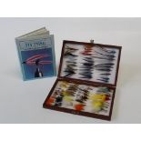 A cased collection of approximately sixty-seven 20th century salmon and trout fishing flies,