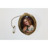 A 19th century French porcelain portrait brooch in gilt metal. Depicting a young girl, with hair