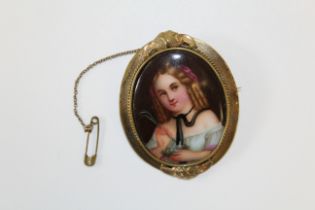 A 19th century French porcelain portrait brooch in gilt metal. Depicting a young girl, with hair