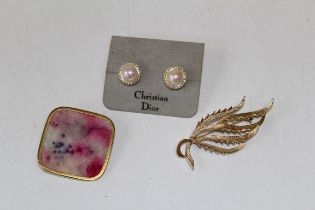 A small lot of costume jewellery featuring a pair of faux pearl Christian Dior studs, on a CD