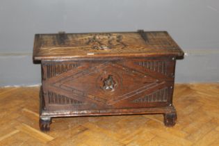 A small oak panel coffer, the rising top carved with a sailing ship, width 84cm