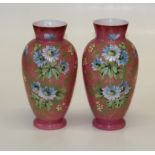 A pair of Edwardian pink satin glass vases, hand decorated with spring flowers. 30.5cm