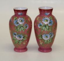 A pair of Edwardian pink satin glass vases, hand decorated with spring flowers. 30.5cm