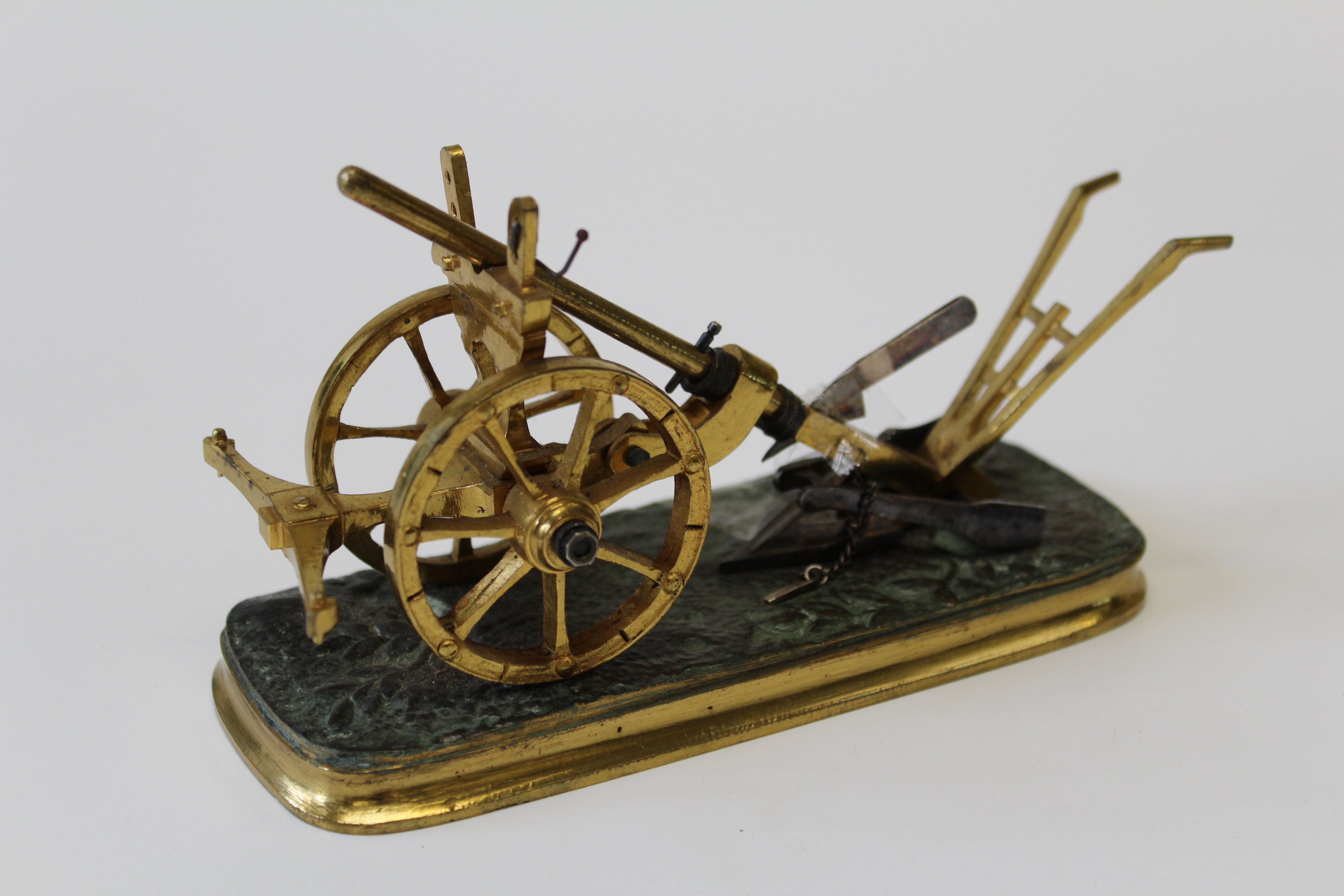 A 20th century miniature gilt metal model of a vintage plough, 15cm long