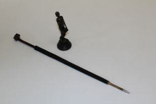 An unsigned hollow cast bronze of a female singer, 19.5cm, together with a parasol form dip pen