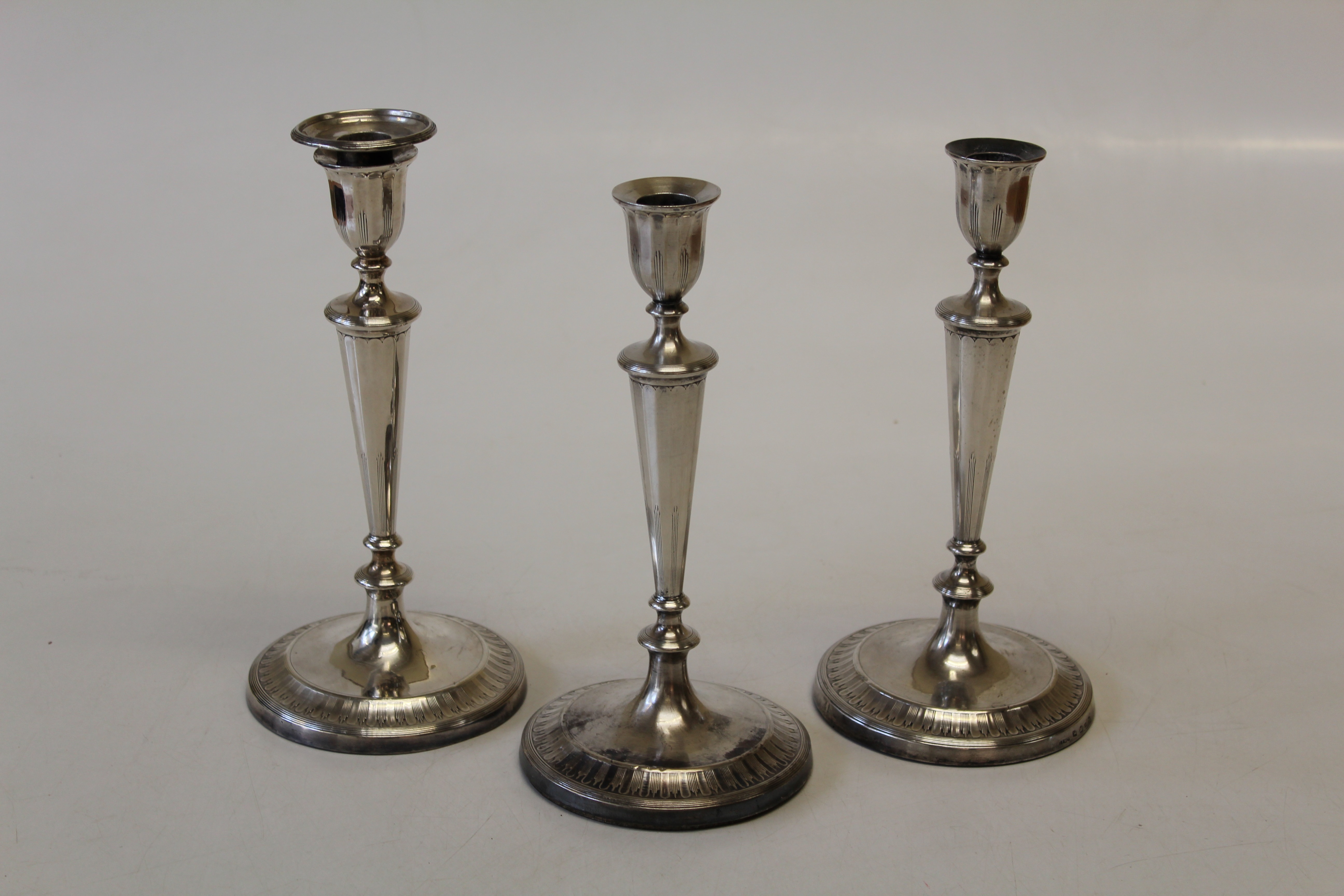 John Green and Company, a pair of William IV silver table candlesticks of tapering form, on loaded