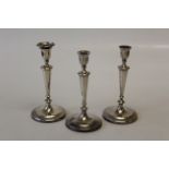 John Green and Company, a pair of William IV silver table candlesticks of tapering form, on loaded
