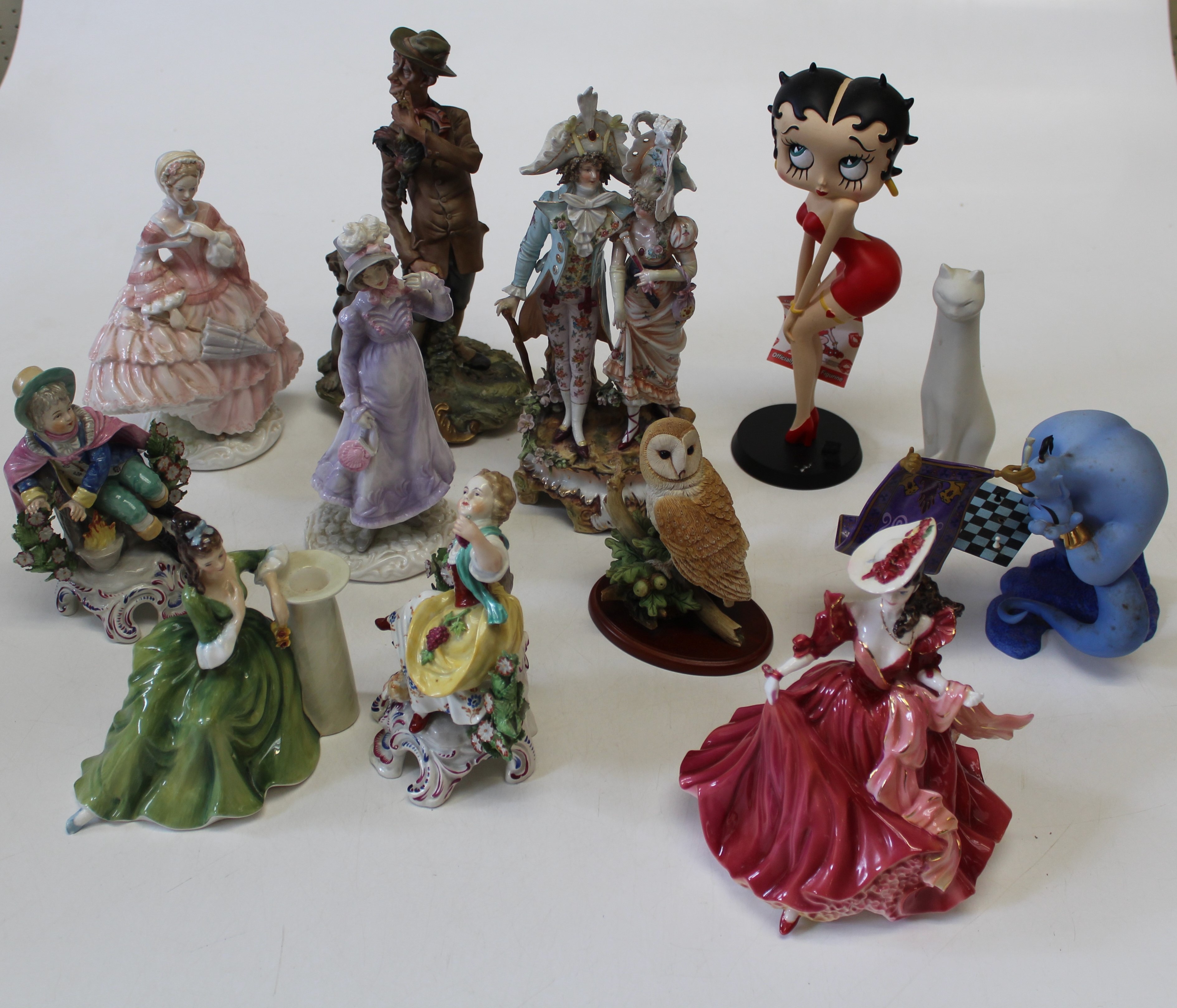 A collection of ceramic figures, to include two Doulton ladies, a Royal Worcester lady, a Coalport