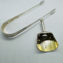 George III tea silver comprising a shovel caddy spoon along with a set of sugar tongs. The caddy