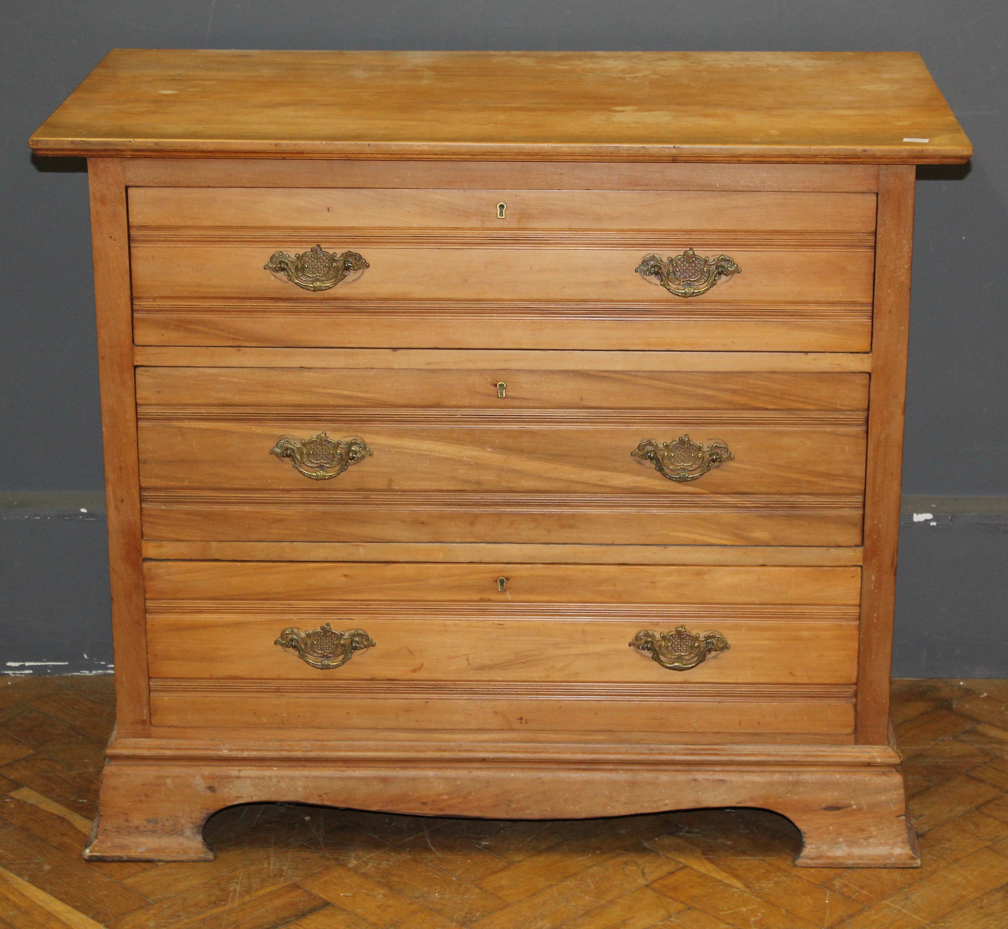 An early 20th century beech chest of drawers, in the Georgian style, with moulded drawer front and