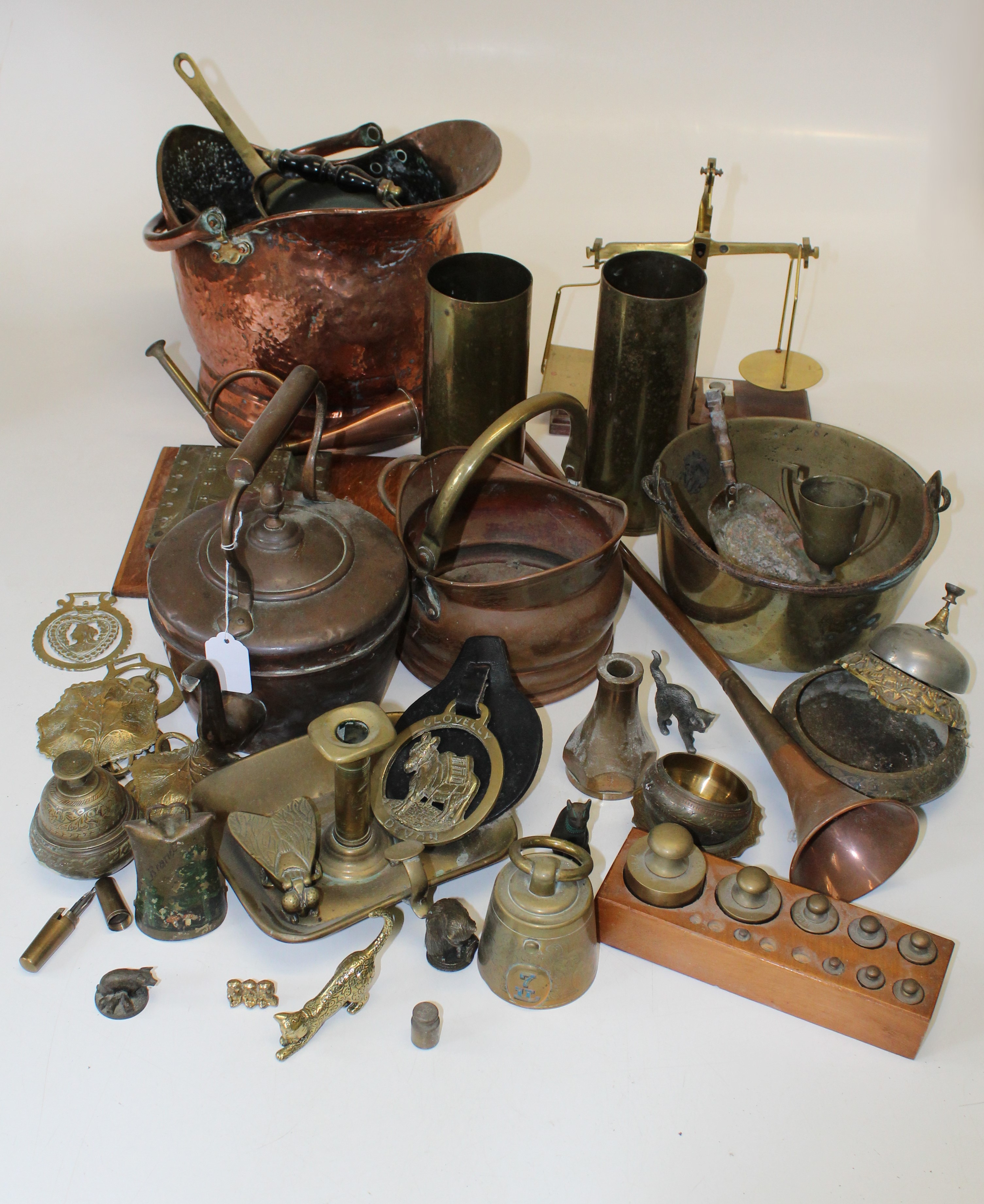 A large quantity of assorted metalwares, to include two copper scuttles, two copper kettles, various