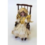 An early 20th century Armand Marseille bisque head doll. Mould number 570. Blonde wig, fixed