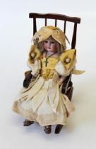 An early 20th century Armand Marseille bisque head doll. Mould number 570. Blonde wig, fixed