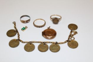 A collection of gold and yellow metal jewellery. To include a garnet set half eternity ring in a "