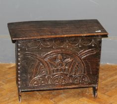 A small oak panel coffer in the 17th century style having a carved front panel, width 67cm