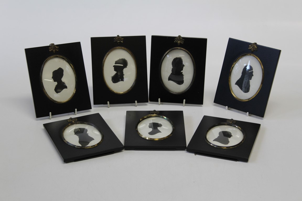 A group of seven 19th century silhouette portrait miniatures, each a member of the Mills family.