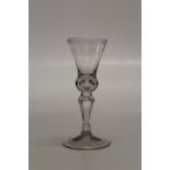 A George III wine glass, the conical bowl over bubble included knop stem on a folding spreading