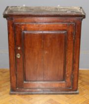 A large oak food/ spice cupboard, the moulded top over a fielded panel door enclosing drawers and