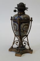 A Doulton Lambeth stoneware oil lamp, by Mark V. Marshall (1843 – 1913), each side decorated in