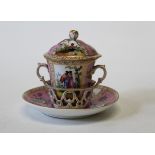 A Dresden porcelain trembleuse chocolate cup and saucer, decorated with gilt highlights on