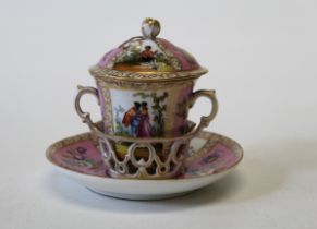 A Dresden porcelain trembleuse chocolate cup and saucer, decorated with gilt highlights on