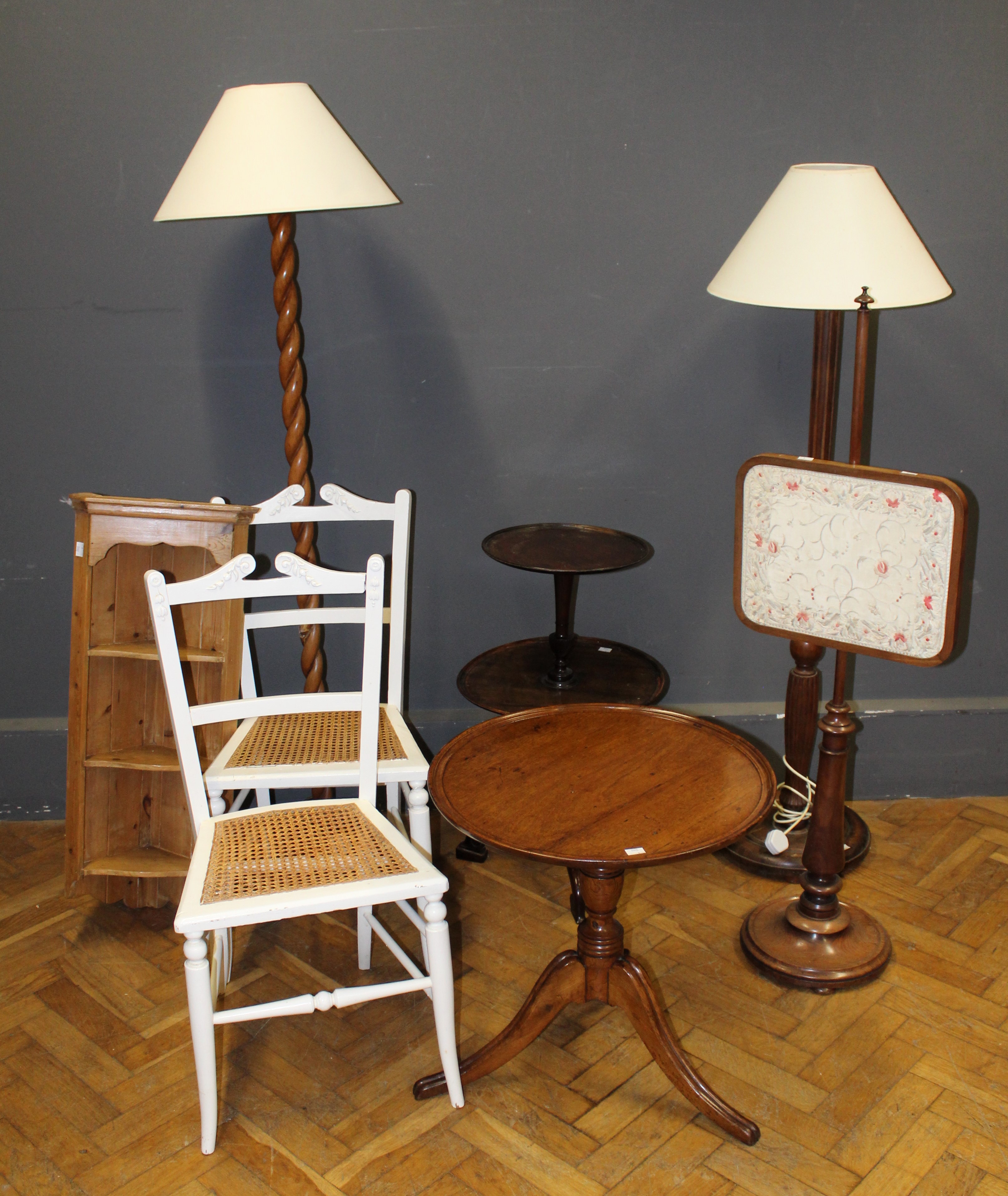 A group of small furniture including two standard lamps, a pair of white painted cane seat chairs,