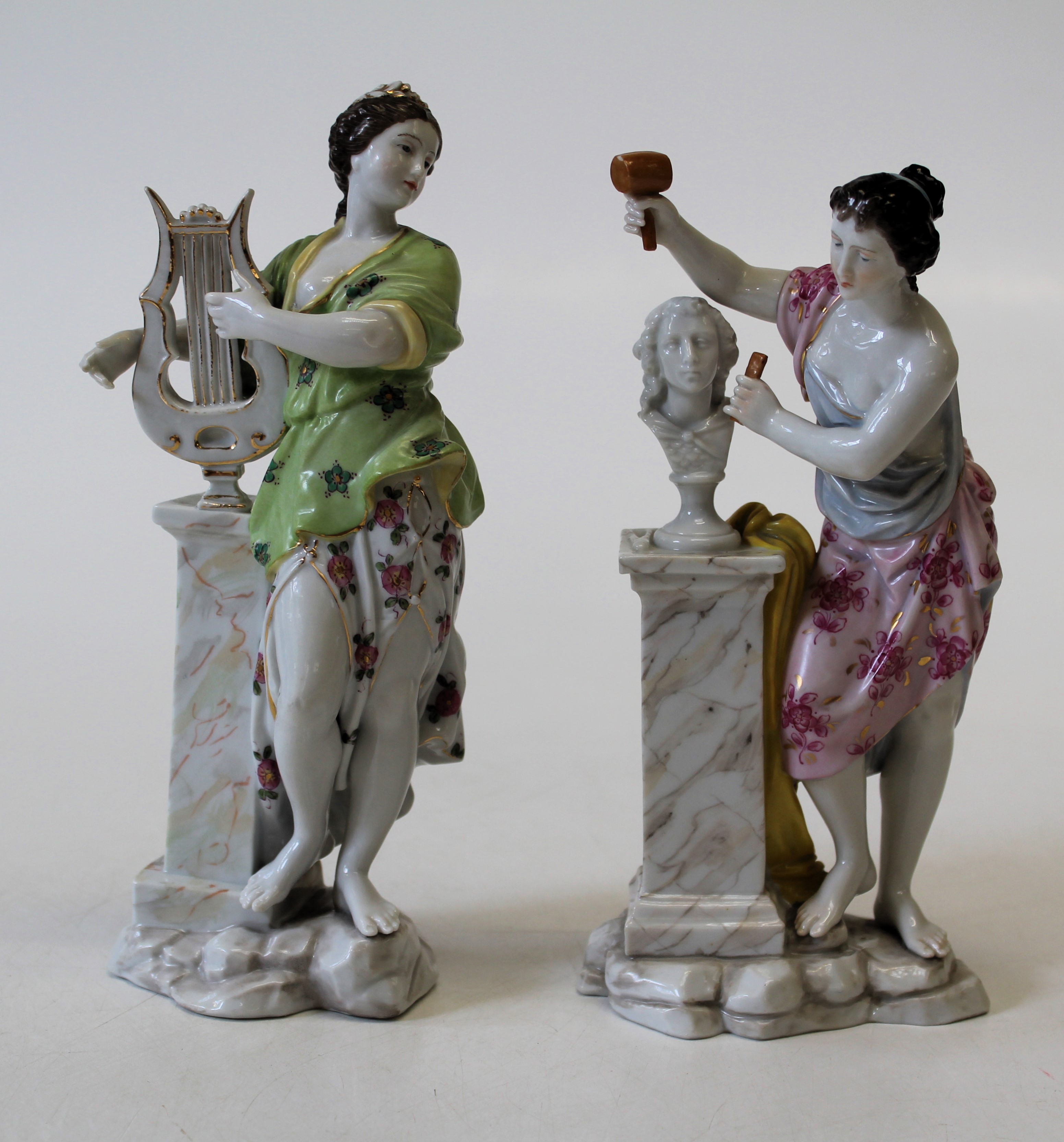 Two 19th century Dresden porcelain figures, each in the form of a female figure stood next to a