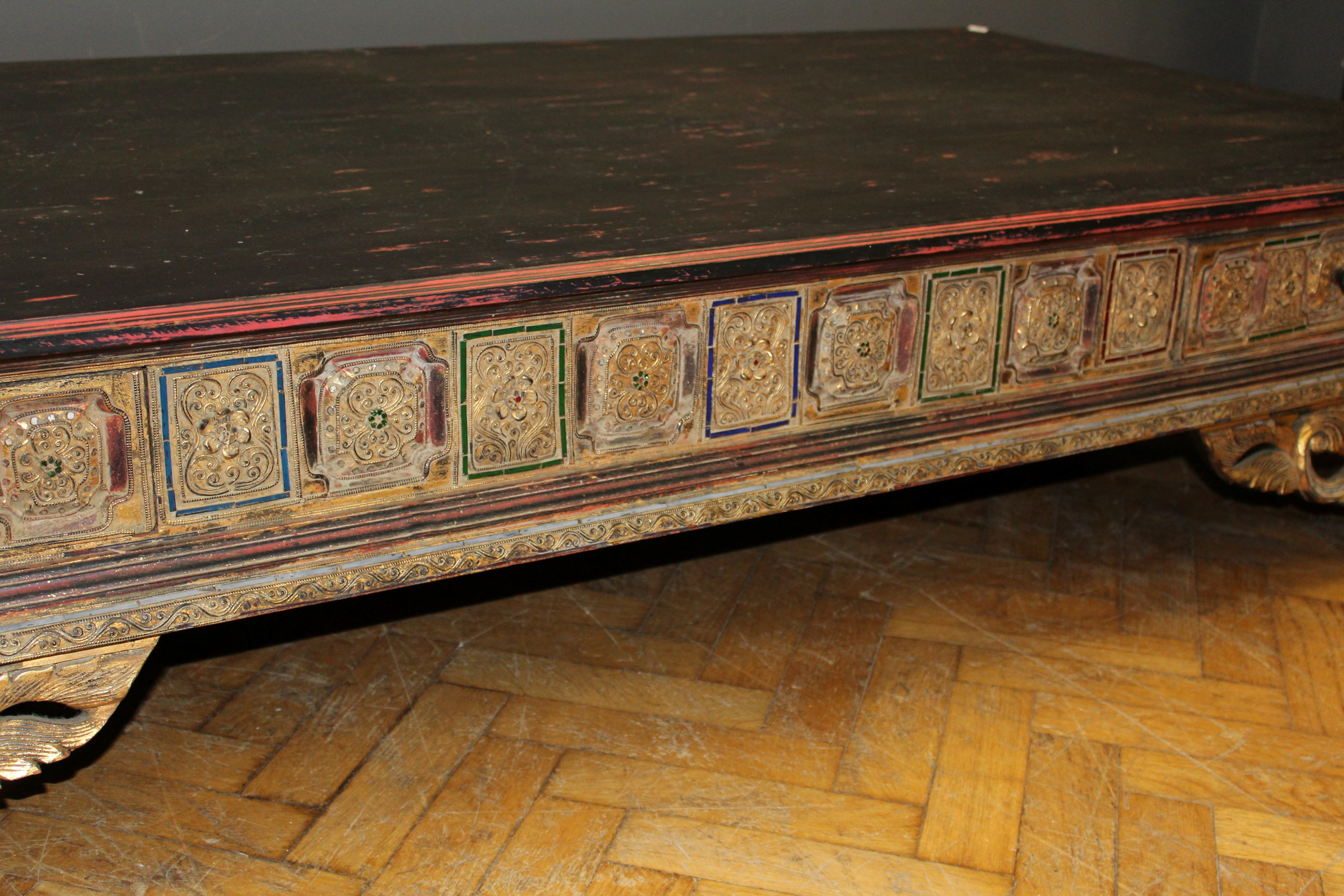 A late 19th / early 20th century Thai carved hardwood and parcel gilt opium bed, set with coloured - Image 2 of 2