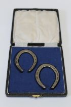 H Hunt, a cased pair of miniature silver horse shoes. Sheffield 1945, 6 x 5cm