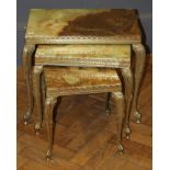 A nesting set of three Italianate onyx and brass occasional tables, the largest 54cm wide