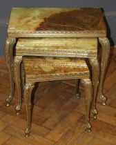 A nesting set of three Italianate onyx and brass occasional tables, the largest 54cm wide
