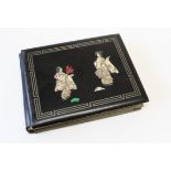 An early 20th century Japanese black lacquer postcard album, containing approximately seventy early/