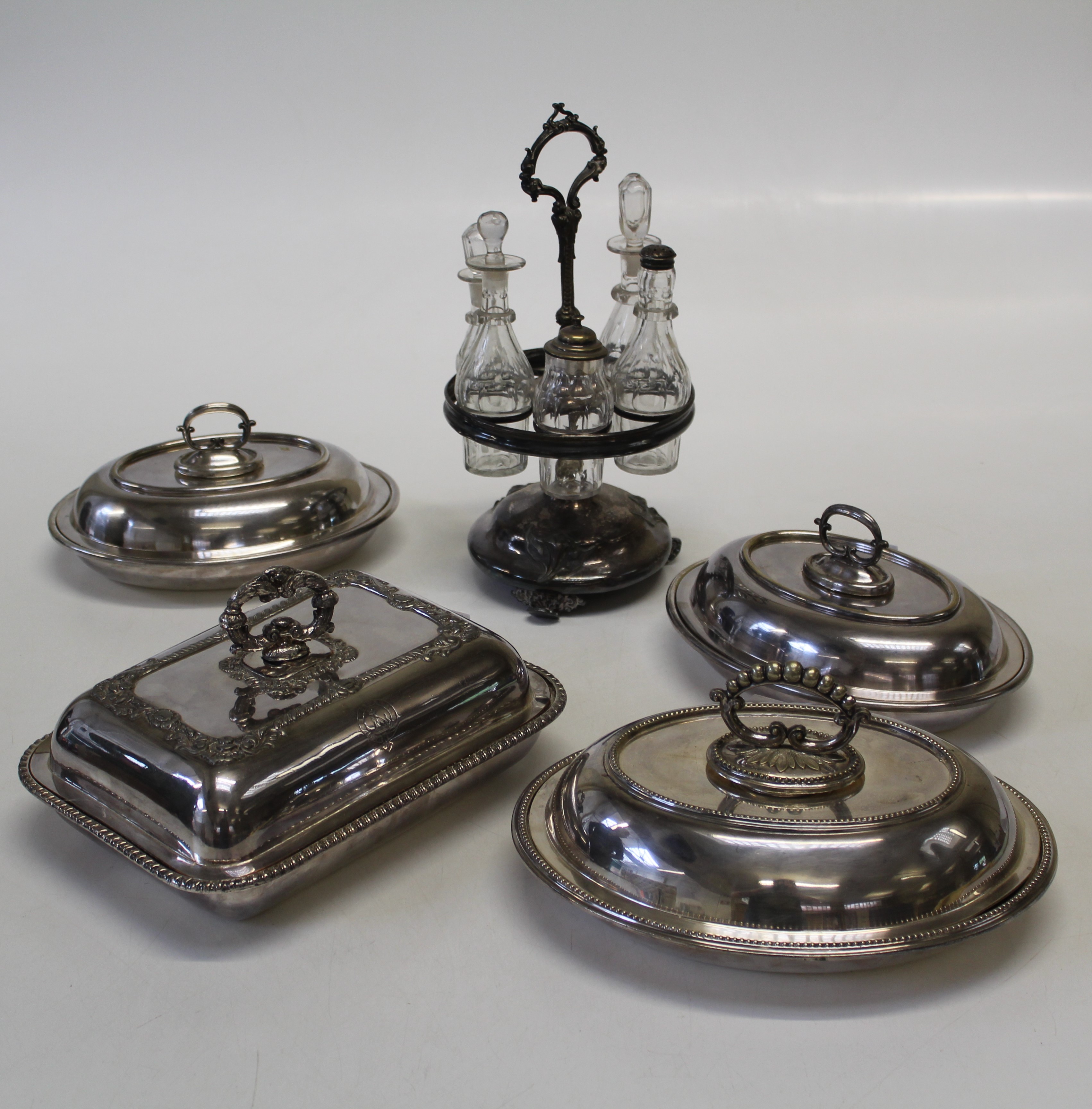 Four silver plated tureen and covers, together with an EPNS five bottle revolving cruet