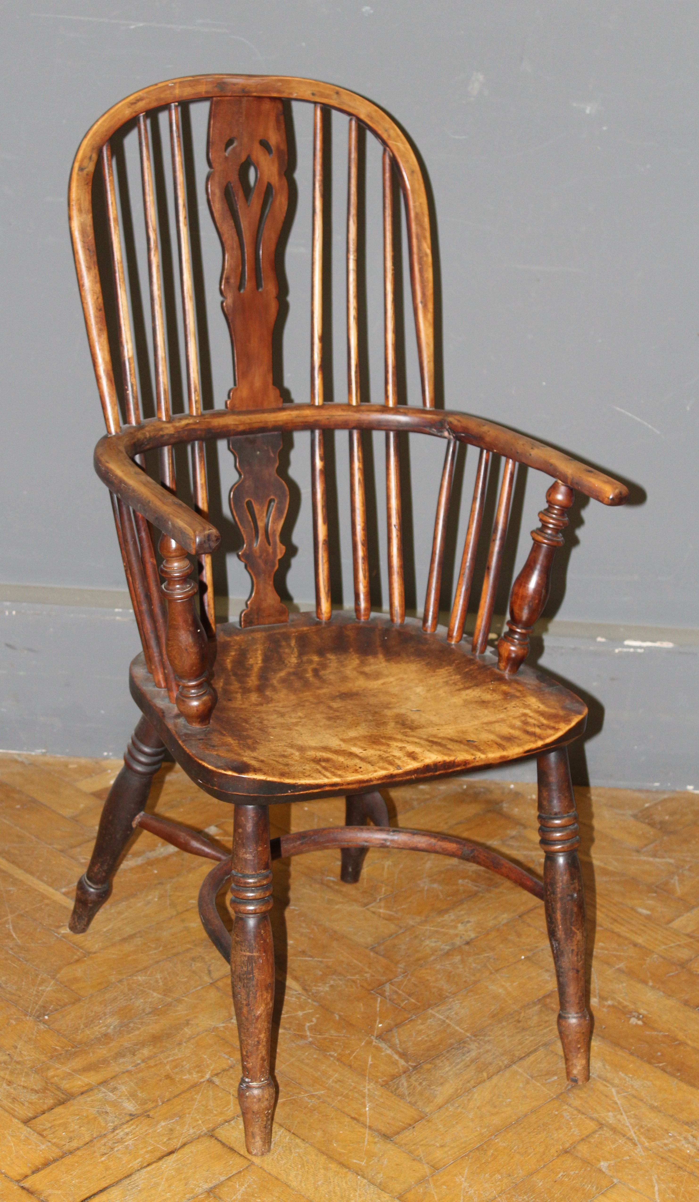 A 19th century yew and elm double hoop and stick back Windsor armchair, with saddle seat, raised