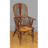 A 19th century yew and elm double hoop and stick back Windsor armchair, with saddle seat, raised