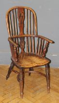 A 19th century yew and elm double hoop and stick back Windsor armchair, with saddle seat, raised