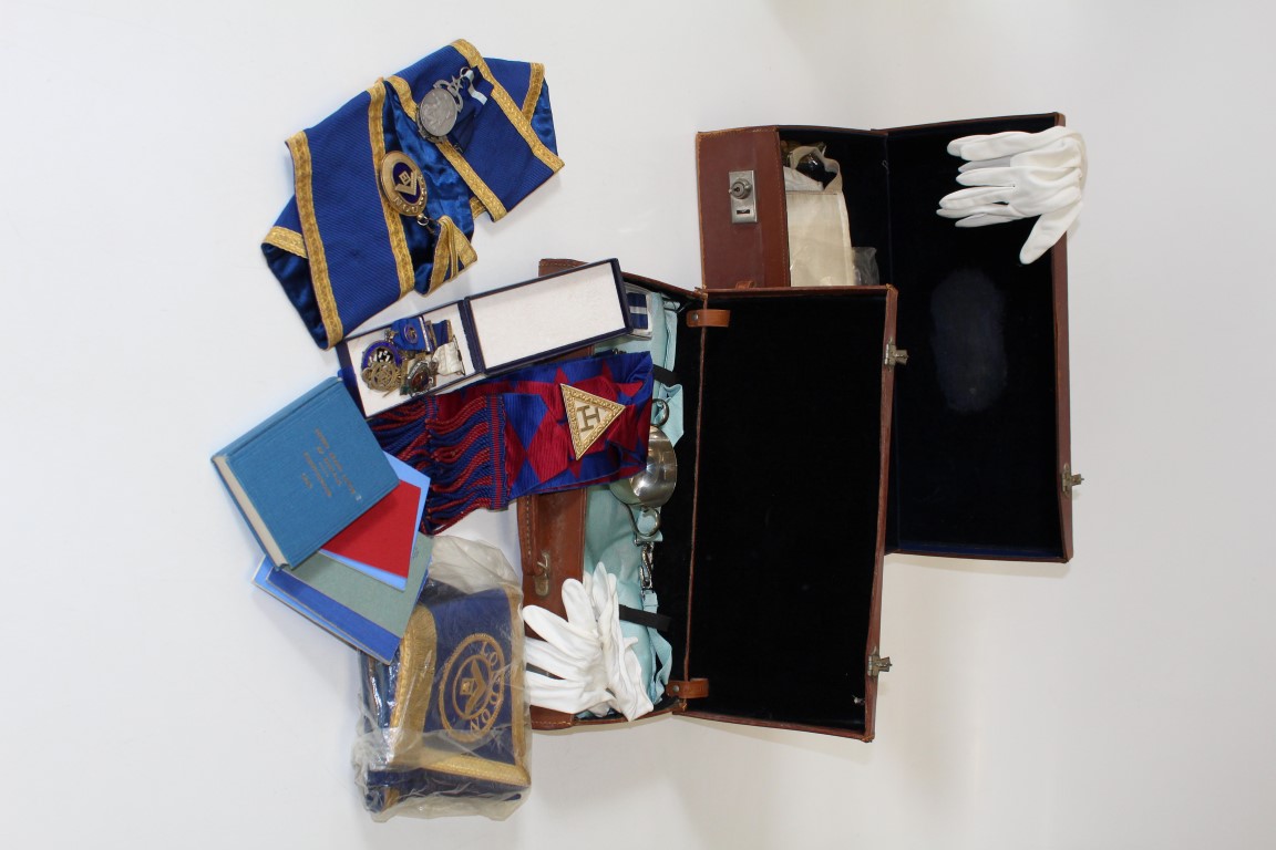 Two early 20th century stitched hide cases containing various Masonic regalia. Including four silver