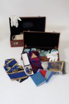 Two early 20th century stitched hide cases containing various Masonic regalia. Including four silver