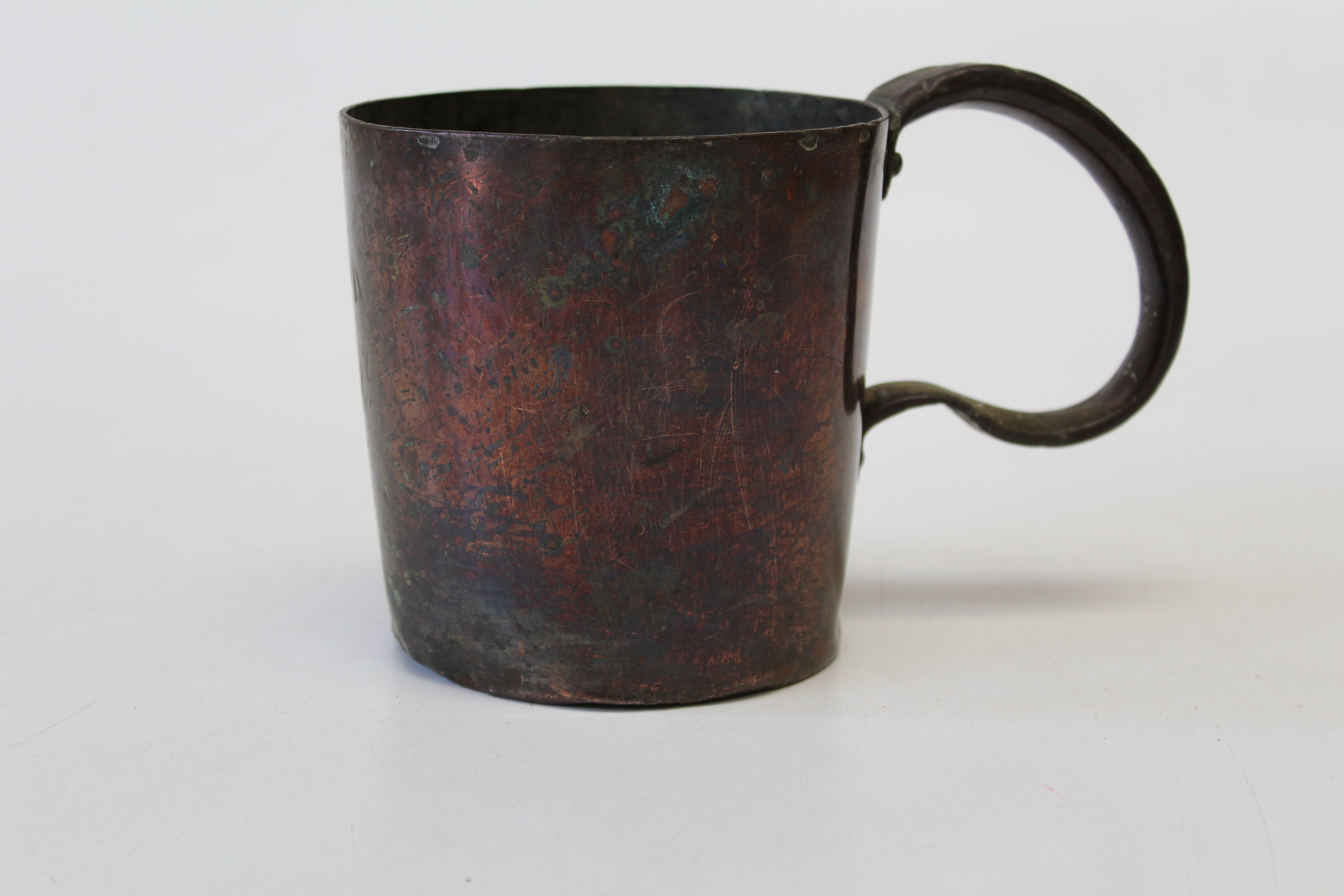 Of Military interest, a crudely formed Victorian copper mug of large size with loop handle. Marked