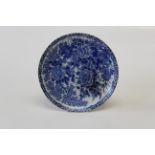 A late 19th century Japanese porcelain blue and white dish, decorated with a perched songbird and