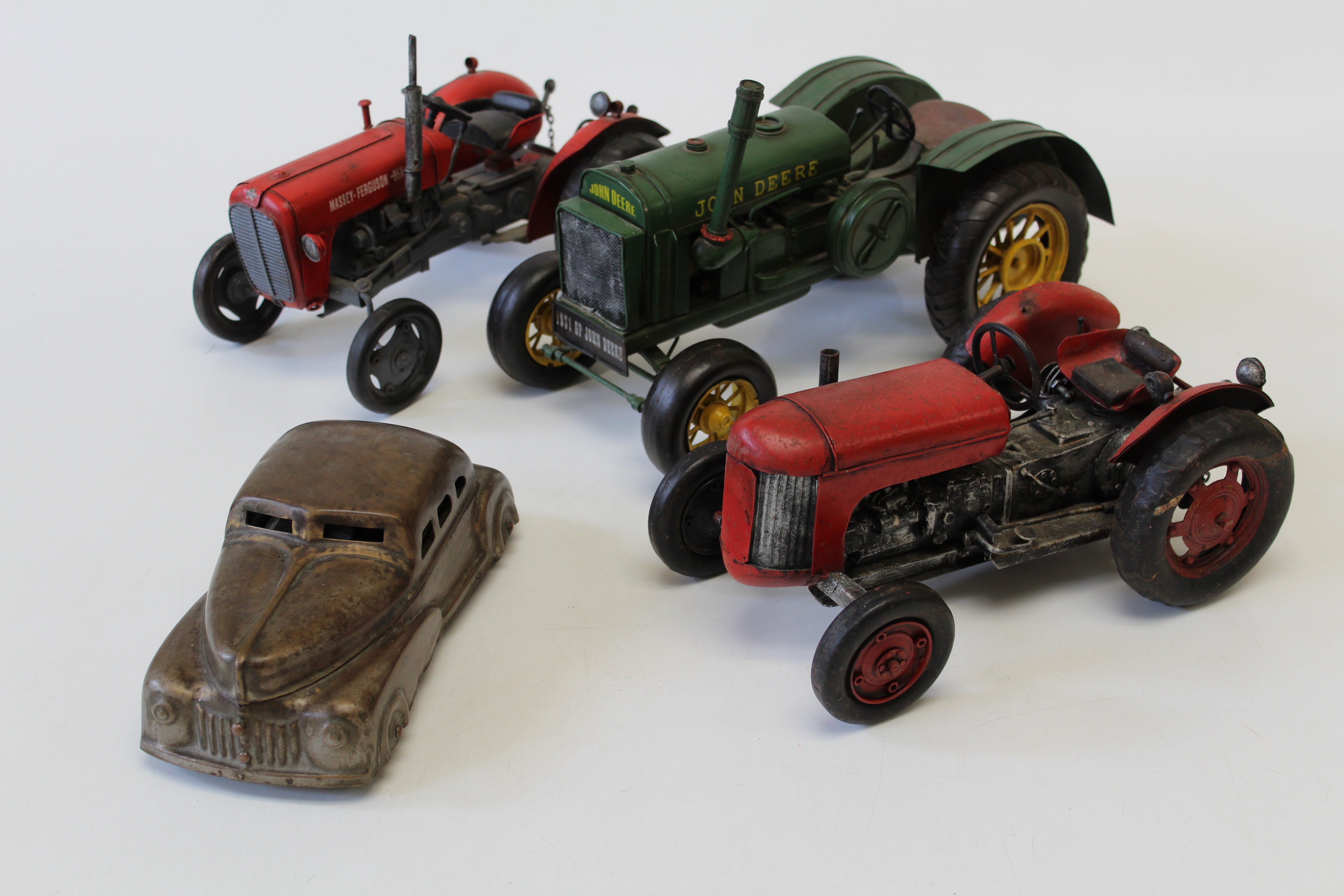 Three scale model tractors, to include a 1931 John Deere in green livery, a Massey Ferguson 35X and