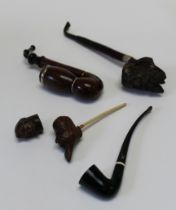 An early 20th century German briar pipe with storm cap, 20cm together with two others, each with