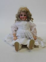 An early 20th century German bisque head doll. Head mould number 3. Blue sleeping eyes and open