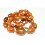 An early 20th century egg yolk amber graduated bead necklace. Each bead has distinct and natural