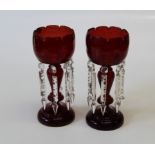 A pair of 19th century ruby glass table lustres, of stemmed form with faceted drops (2)