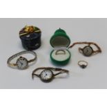 A collection of 9ct gold jewellery to include two dress rings and two gold cased wristwatches, one