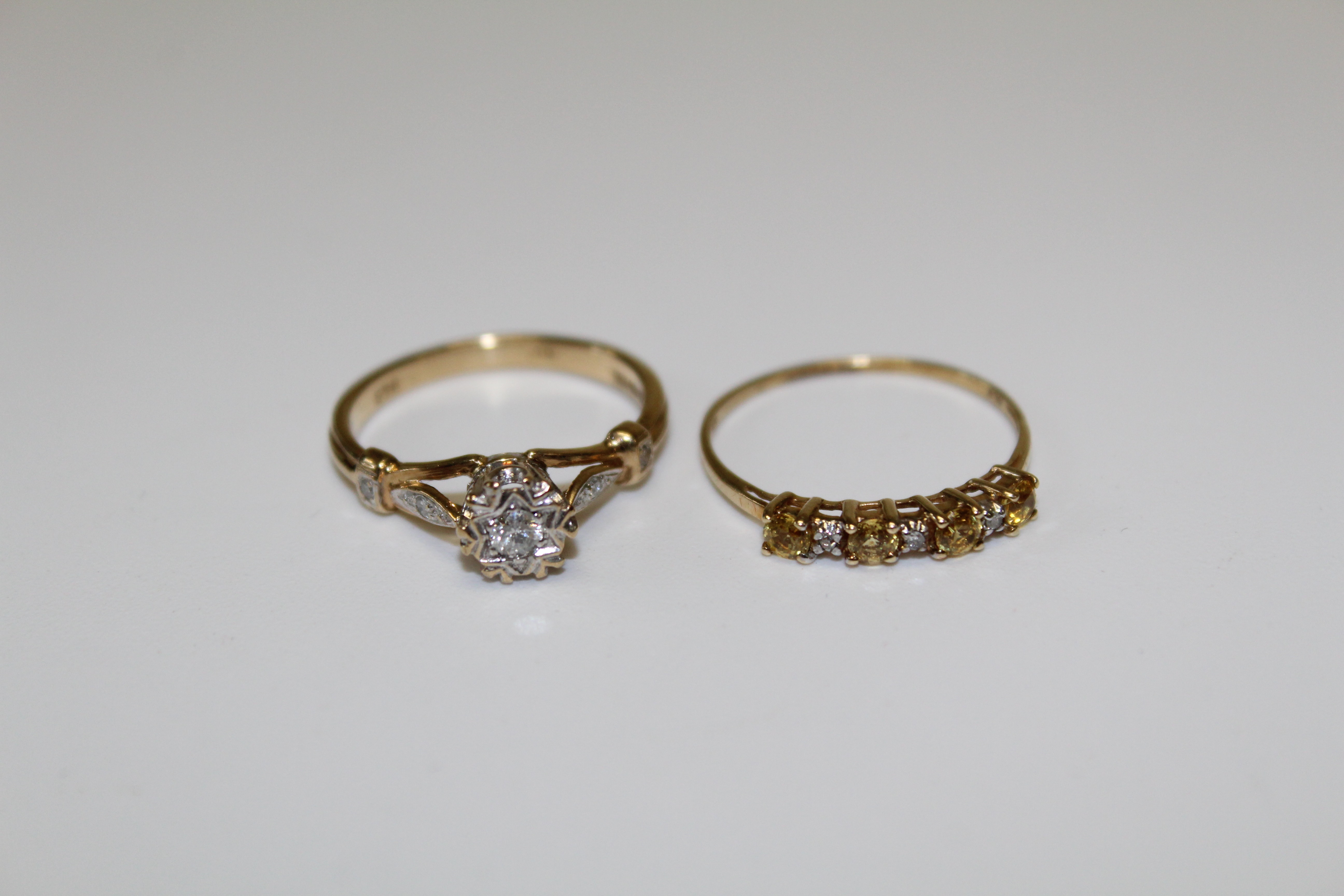 A 9ct gold diamond set solitaire ring, featuring an illusion set 0.05carat diamond in a snowflake