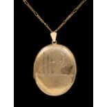 A 9ct gold oval locket, engraved, depicting river scene with a swan, length approx 38mm, suspended