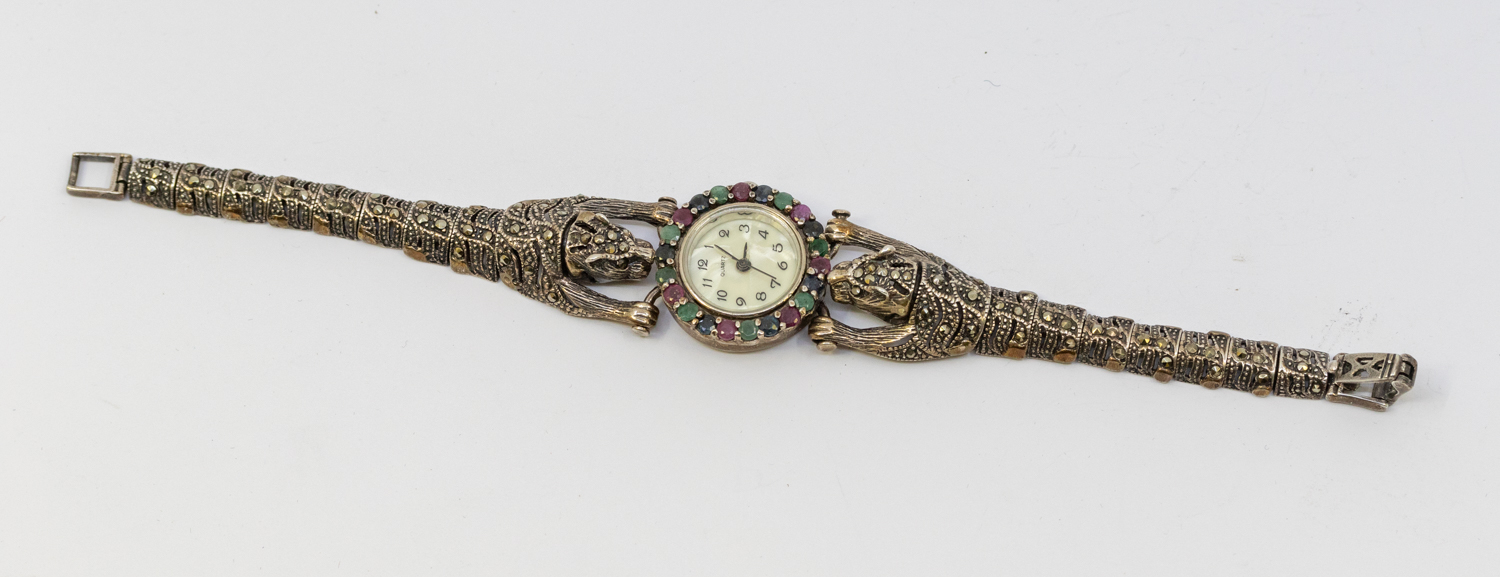 A ladies silver 925 gem set wristwatch, comprising a pearlized dial with arabic markers, the bezel